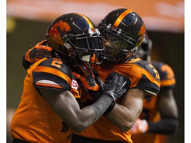 BC Lions #2 Chris Rainey ( L ) and #20 Keynan Parker ( R ) celebrate Rainey's TD against the Calgary Stampeders in a regular season CFL football game at BC Place, Vancouver June 25 2016.