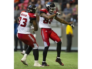 Calgary Stampeders #33 Jerome Messam and #88 Kamar Jorden celebrate Jorden's touchdown against the BC Lions in a regular season CFL football game at BC Place, Vancouver June 25 2016.