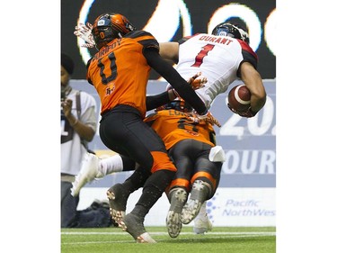 BC Lions #0 Loucheiz Purifoy and #8 Bo Lokombo tackle  Calgary Stampeders #1 Lemar Durant in a regular season CFL football game at BC Place, Vancouver June 25 2016.
