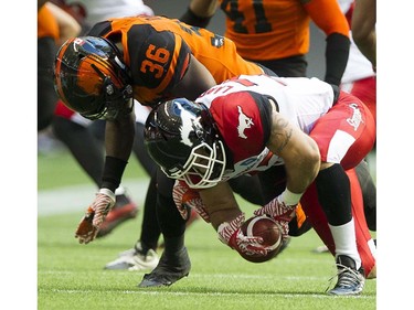 BC Lions #36 Dyshawn Davis covers Calgary Stampeders #23 William Langlais as he recovers the ball in a regular season CFL football game at BC Place, Vancouver June 25 2016.
