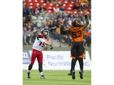 BC Lions #53 Alex Bazzie is unable to block a pass from Calgary Stampeders #19 Bo Levi Mitchell in a regular season CFL football game at BC Place, Vancouver June 25 2016.