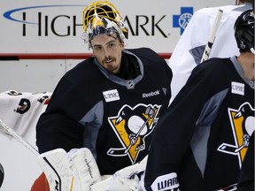 Pittsburgh Penguins' Marc-Andre Fleury, right, takes a break during hockey practice at the Consol Energy Center in Pittsburgh, Sunday May 29, 2016. The Penguins are preparing for Game 1 of the Stanley Cup Finals against the San Jose Sharks on Monday, May 30, in Pittsburgh.