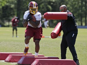 Washington Redskins running back Matt Jones (31) runs a drill during practice at the team's NFL football training facility in Ashburn, Va.  The Redskins are one of six NFL teams using so-called beeping or whistling footballs to emphasize ball security.