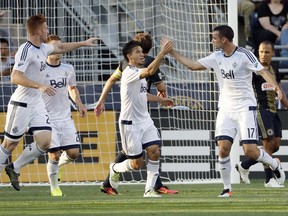 Vancouver Whitecaps Andrew Jacobson (17) and Nicolas Mezquida (11) celebrate after Jacobson's goal during the first half of an MLS soccer match against Philadelphia Union, Saturday, June 25, 2016, in Chester, Pa.