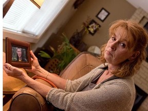 Sandra Tully with a photo of her son, Ryan Pinneo, who died after taking pills laced with fentanyl.