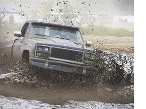 A truck motors through the mudflats at Stave Lake near Mission, B.C., on Sunday, May 8, or "Mudders Day."