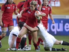 Canada's centre Andrea Burk runs with the ball during the IRB Women's Rugby World Cup final match between England and Canada at the Jean Bouin Stadium on August 17, 2014 in Paris.