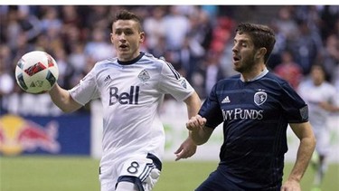 Vancouver Whitecaps FC defender Fraser Aird and Sporting Kansas City midfielder Connor Hallisey (22) fight for control of the ball during the first half of MLS soccer action in Vancouver, B.C. Wednesday, April 27, 2015. Rangers, the Glasgow club that loaned Aird to the Vancouver Whitecaps this season, fell 3-2 to Hibernian in dramatic fashion over the weekend, and while the defeat was a major disappointment, what happened next left the 21-year-old defender shaking his head. THE CANADIAN PRESS/Jonathan Hayward