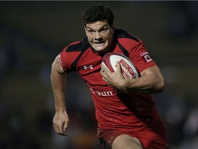 Ciaran Hearn #10 of Canada makes a break against Fiji during the Third Place Playoff match on day two of the Tokyo Sevens Rugby 2015 at Chichibunomiya Rugby Stadium on April 5, 2015 in Tokyo, Japan.