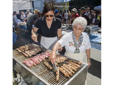 Mina Ma, left, and Voula Tentes grill souvlaki at Greek Day on West Broadway in Vancouver, B.C., June 26, 2016.