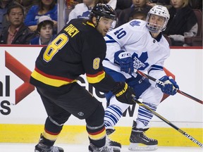 The Canucks' Chris Tanev, shown playing against Michael Grabner and the Toronto Maple Leafs last season, has become one of the best defensive defencemen in the NHL.