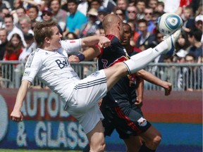 Terry Dunfield #7 of the Vancouver Whitecaps FC kicks the ball beside Joel Lindpere #20 of the New York Red Bulls during their MLS match May 28, 2011 in Vancouver, British Columbia, Canada. Vancouver and New York tied 1-1. (Photo by Jeff Vinnick/Getty Images)