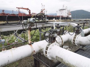 A ship receives its load of oil from Kinder Morgan’s Trans Mountain Pipeline Westridge Marine Terminal loading dock in Burnaby.