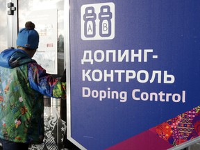 FILE - In this Feb. 21, 2014, file photo, a man walks past a sign reading doping control, at the Laura biathlon and cross-country ski center, at the 2014 Winter Olympics in Krasnaya Polyana, Russia.  On Monday, July 18, 2016 WADA investigator Richard McLaren confirmed claims of state-run doping in Russia.  (AP Photo/Lee Jin-man, File)