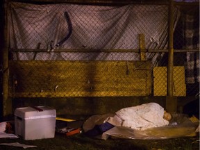 A homeless woman sleeps at a tent city at Oppenheimer Park in Vancouver's Downtown Eastside.