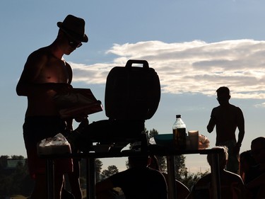 Jonas Love barbequed burgers and vegatables while waiting for the start of the first night of The Celebration of Light.  Rob Kruyt Photo