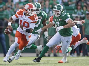 B.C. Lions quarterback Jonathon Jennings (#10) takes off with the ball under pressure from Saskatchewan Roughriders defensive lineman Justin Capicciotti (#7) during first half CFL action in Regina on Saturday, July 16th, 2016.