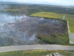 Smoke rises from the site of a wildfire burning in Burns Bog.