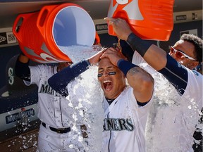 Leonys Martin of the Seattle Mariners is doused by teammates after hitting a walkoff home run in the eleventh inning against the Chicago White Sox at Safeco Field on July 20, 2016 in Seattle, Washington.
