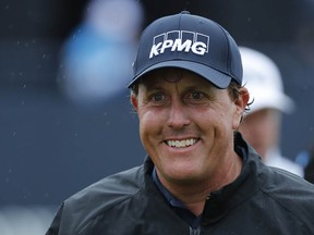 He's all smiles now, but this is going to be a long, long weekend for 46-year-old Phil Mickelson. (AP)