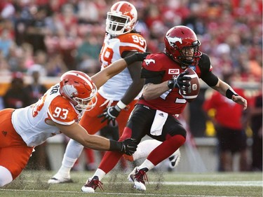 Calgary Stampeders quarterback Bo Levi Mitchell is sacked by BC Lions' Craig Roh during first half CFL football action in Calgary, Friday, July 29, 2016.