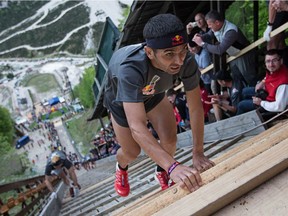 Competitors in the Red Bull 400 scramble up Whistler's ski-jump hill