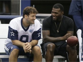 In this June 18, 2015, file photo, Dallas Cowboys wide receiver Dez Bryant, right, sits on the bench with quarterback Tony Romo (9) during mini-camp at the team's stadium in Arlington, Texas. Both are anxious to get on the field together after injuries kept them apart most of last season, when Dallas slid from first to worst in the NFC East.