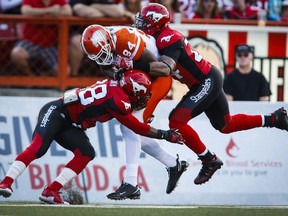 B.C. Lions' Eric Fraser, centre, celebrates with teammate Steven Clarke, after running in an interception for a touchdown against the Calgary Stampeders during first half CFL action in Calgary on Friday, July 29, 2016.