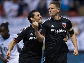 D.C. United's Fabian Espindola, left, of Argentina, and Bobby Boswell celebrate Boswell's goal against the Vancouver Whitecaps during a 2015 game at B.C. Place. Espindola was supposed to help shore up the Caps defence, but Vancouver turned around and transferred his rights to a Mexican team earlier this week.