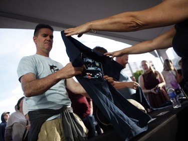 Fans buy t-shirts before the start of the Tragically Hip's Man Machine Poem Tour outside the Save-On-Foods Memorial Centre in Victoria on Friday.