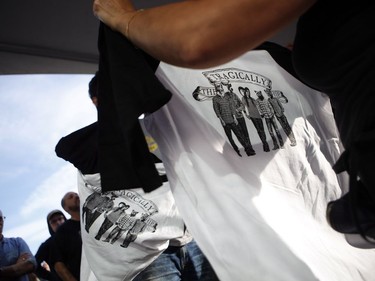 Fans buy t-shirts before the start of the Tragically Hip's Man Machine Poem Tour outside the Save-On-Foods Memorial Centre in Victoria on Friday.