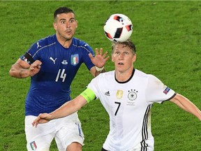 Italy's midfielder Stefano Sturaro (L) vies for the ball with Germany's midfielder Bastian Schweinsteiger during the Euro 2016 quarter-final in Bordeaux last week. Schweinsteiger, the team captain, is doubtful for the semifinal against France, while striker Mario Gomez has been ruled out of the rest of Euro 2016 because of injury.