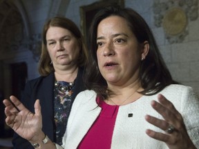 Minister of Health Jane Philpott looks on as Jody Wilson-Raybould, minister of justice and attorney general, responds to a question from the media about Bill C 14 in the Foyer of the House of Commons on June 16 in Ottawa.
