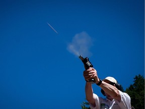 A bullet flies through the air as John Simmons, of Whitehorse, Yukon, fires a shot at a target during the International Practical Shooting Confederation (IPSC) Canada National Championships in Pitt Meadows, B.C., on Thursday July 31, 2014.