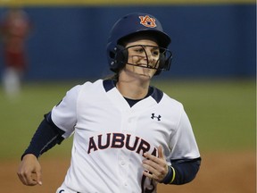 Auburn's Kasey Cooper smiles as she rounds the bases after a home run against Oklahoma in the championship series of the NCAA softball Women's College World Series in Oklahoma City on June 7. Cooper is now competing at the WBSC softball worlds at Softball City. — The Associated Press files