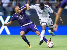 Orlando City's Kevin Alston, left, and Vancouver Whitecaps' Alphonso Davies vie for the ball during the second half of an MLS soccer game at B.C. Place in July of 2016. It was Davies' first MLS game.