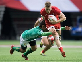 Canada's Conor Trainor, right, is hit by Brazil's Lucas Duque as he carries the ball during World Rugby Sevens Series' Canada Sevens tournament action, in Vancouver, B.C., on Sunday March 13, 2016.