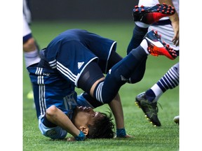 Vancouver Whitecaps forward Masato Kudo takes a tumble after failing to get his head on the ball during Wednesday's 2-0 win over Real Salt Lake.