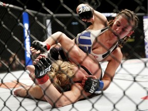 Miesha Tate, right, dominates Holly Holm during their UFC 196 women's bantamweight mixed-martial arts match on March 5 in Las Vegas. Ronda Rousey’s shadow continues to hang over Tate.
