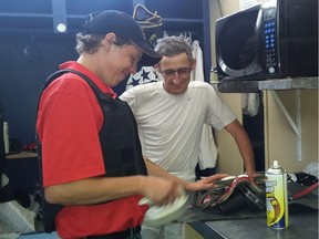 Recently retired jockey Scott William, left, works under the watchful eye of leading rider Richard Hamel at his new job working as a jockeys' valet inside the Hastings jockeys' room.