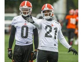 BC Lions Ryan Phillips, right chats with Loucheiz Purifoy, left.