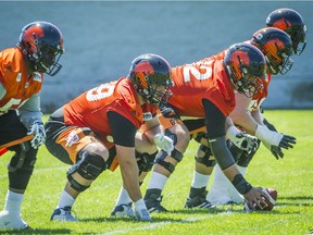 B.C. Lions centre Cody Husband, right, leads the offensive line during practice at their facility in Surrey on June 28. With five starters either new to the team or new to their deployment on the O-line, the unit has been a driver in the Lions’ surprising 3-1 start.
