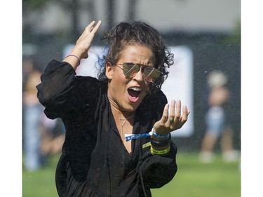 A woman reacts to the cold water at the misting area at FVDED in the Park.