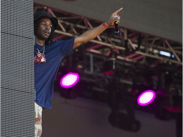 Jazz Cartier climbs the stage tower as he performs at FVDED in the Park.