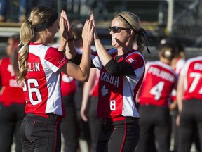 Canada's Larissa Franklin, left, and Victoria Hayward get set to play Italy at the the Women's World Softball Championships at Softball City,  Surrey, on Friday.