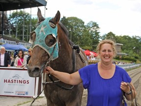 Trainer Laci Burningham and their former family riding horse, P.S. Crosby, leave the winners' circle their win last Sunday at Hastings Racecourse.