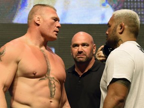 UFC president Dana White looks on as mixed martial artists Brock Lesnar, left, and Mark Hunt face off during their weigh-in for UFC 200 on July 8 in Las Vegas. White will stay on as president following the sale of UFC to William Morris Endeavor and International Management Group.