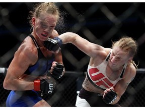 Valentina Shevchenko, right, of Kyrgyzstan, punches Holly Holm during a women's bantamweight mixed martial arts bout in Chicago, Saturday, July 23, 2016.