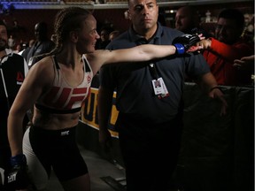 Valentina Shevchenko, left, of Kyrgyzstan, celebrates with fans after defeating Holly Holm in a women's bantamweight mixed martial arts bout at United Center in Chicago, Saturday, July 23, 2016.