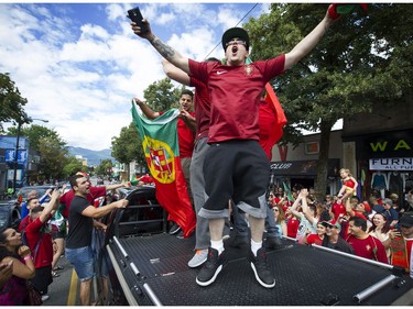 Vancouver   B.C.  July 10, 2016   Portuguese fans go wild on Vancouver's Commercial Drive as they celebrate Portugal beating  France to win Euro 2016 soccer tournament, which took place in France.   Mark van Manen/ PNG Staff photographer   see  Vancouver Sun/ Province Sports  /News Features and Web. stories   00043697A [PNG Merlin Archive]